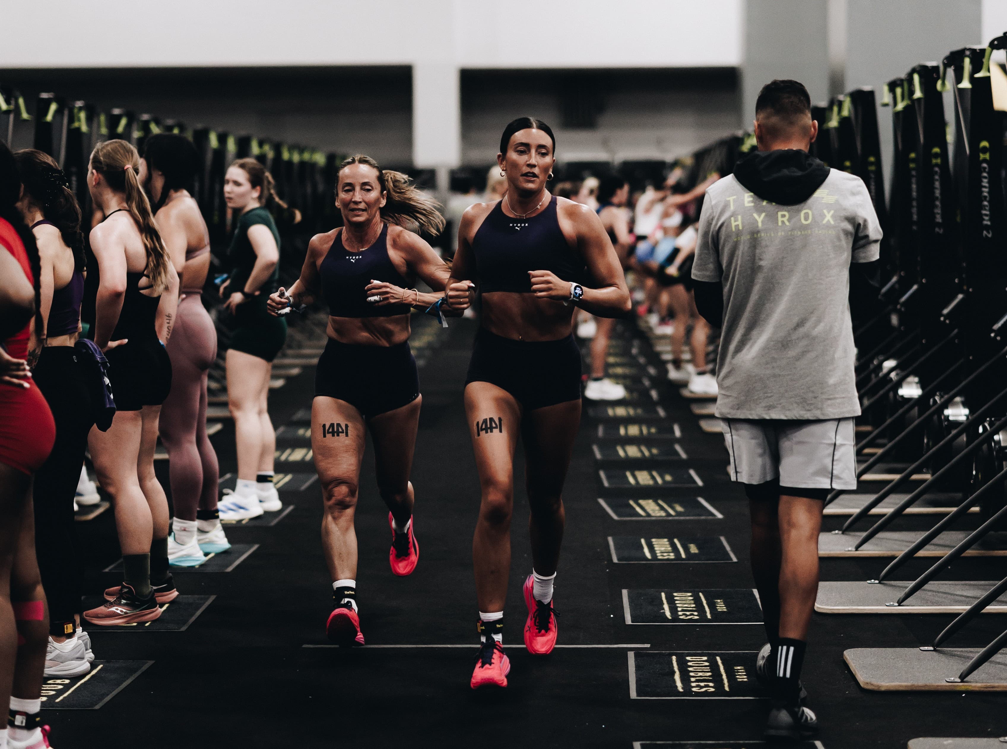 Two women competing in HYROX