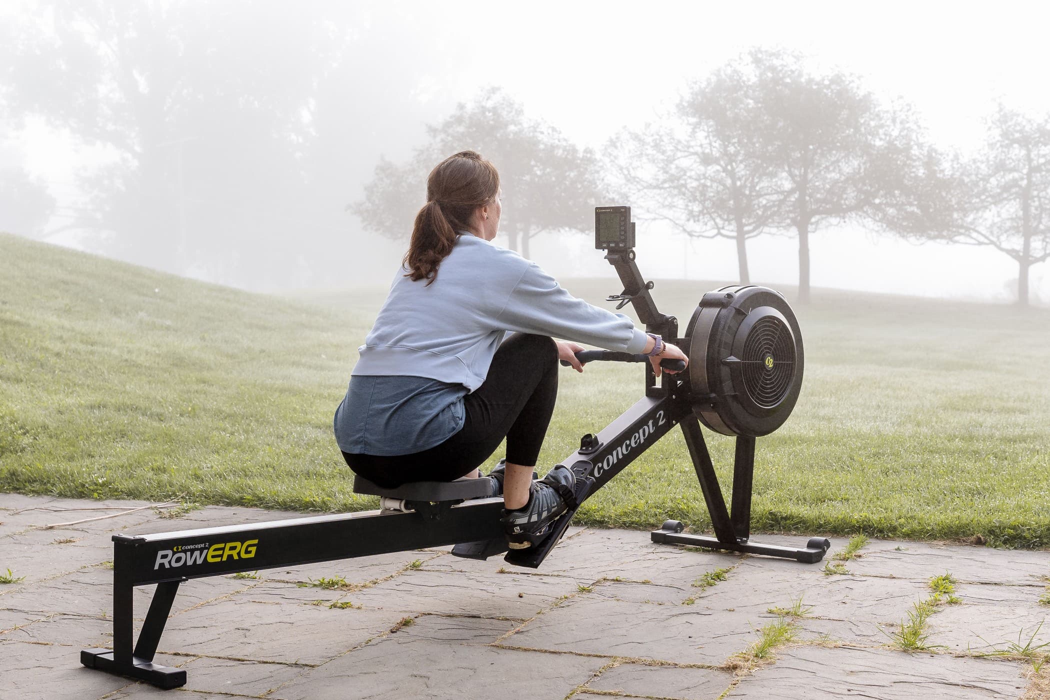 woman outside on concept2 rowerg