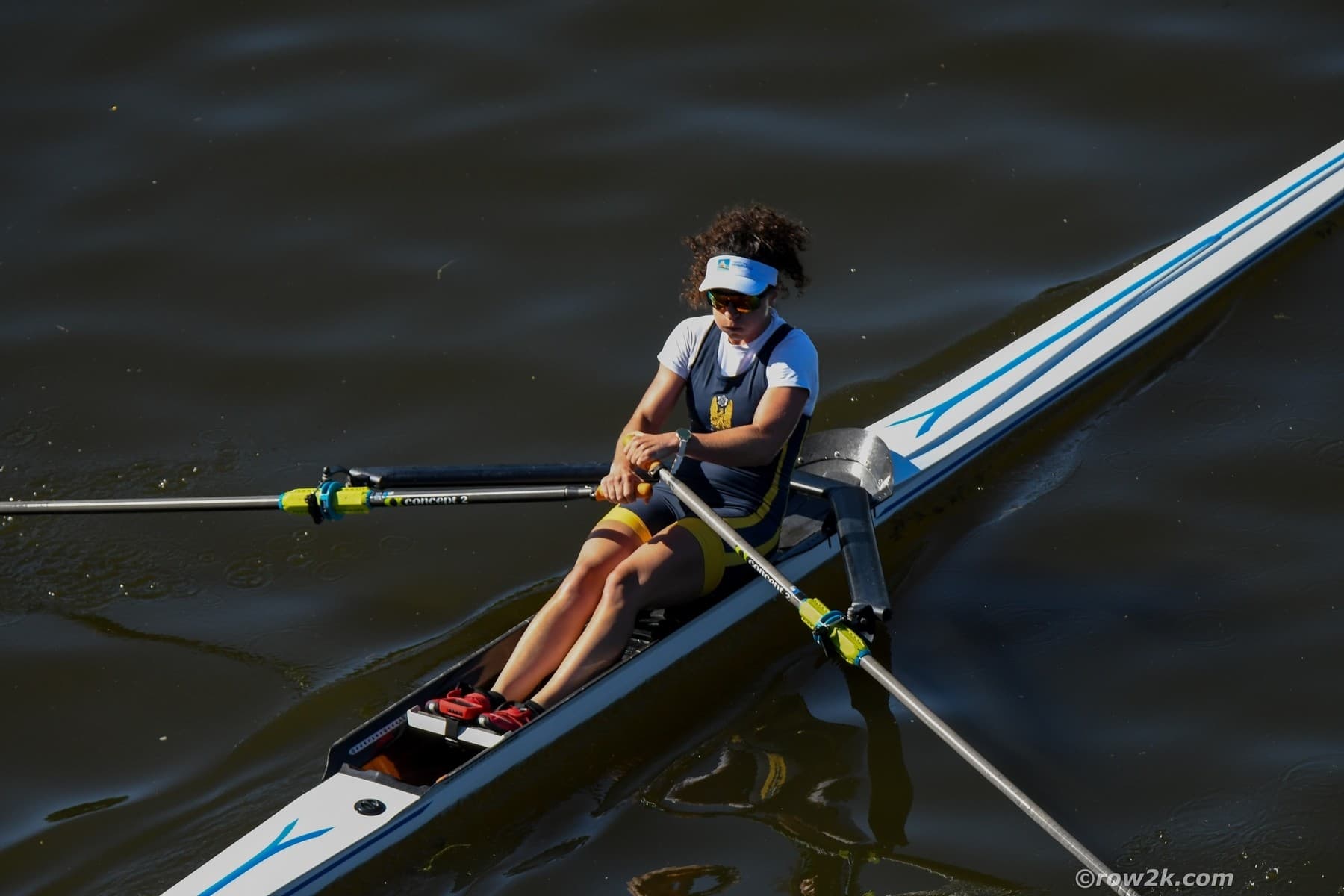 Woman rowing single with Concept2 oars